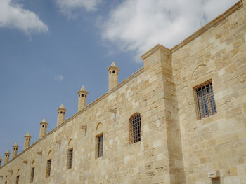 Low angle view of church against cloudy sky