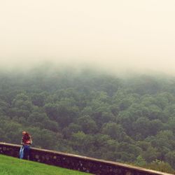 Woman on mountain against sky