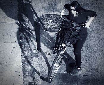 High angle view of man standing on bicycle in city