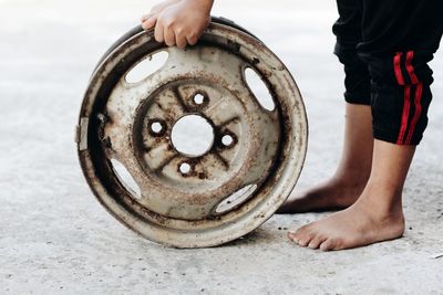 Low section of person with wheel rim