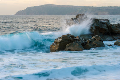 Waves splashing on rocks in sea