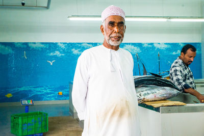 Portrait of friends standing at market stall