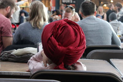 Rear view of people sitting in train