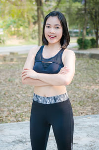 Portrait of smiling young woman standing outdoors