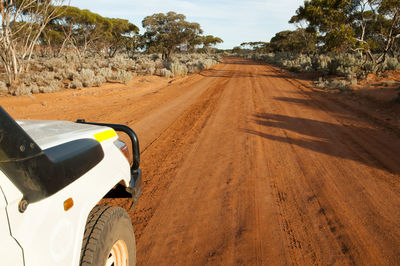 Road amidst desert against sky