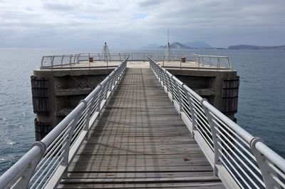 Pier over sea against sky