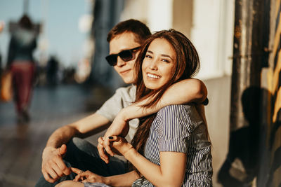 Portrait of young couple sitting outdoors