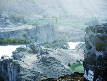Scenic view of waterfall against mountains
