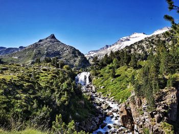 Scenic view of mountains against clear blue sky