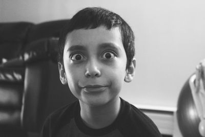 Portrait of boy making a face while sitting at home