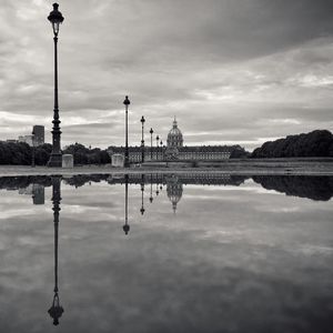Reflection of hotel des invalides and lighting equipment on pond