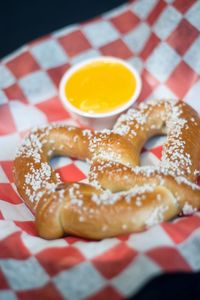 Close-up of pretzel with cheese in paper