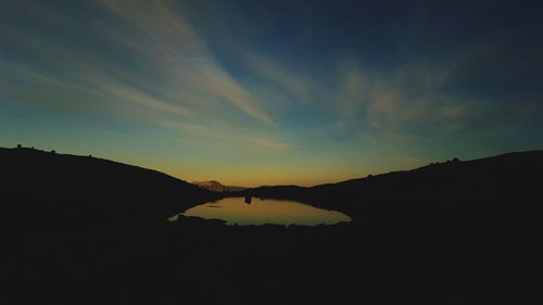 Scenic view of silhouette mountain against sky during sunset