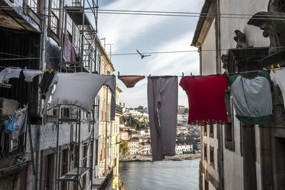 Clothesline amidst buildings in city