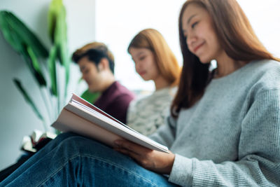 Group of young people sitting and enjoyed reading books together