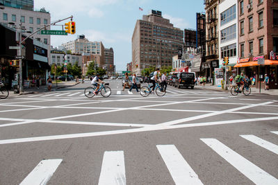 Group of people crossing road in city