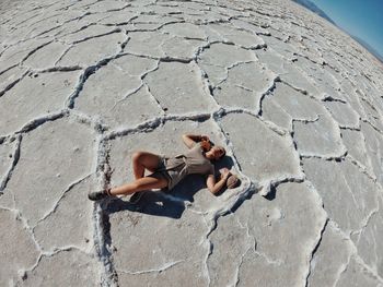 High angle view of woman lying on land