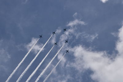 Low angle view of airshow against sky