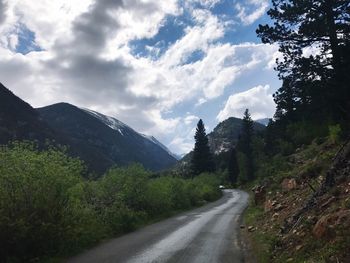 Scenic view of road and mountains against sky