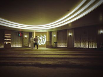 Man in illuminated room