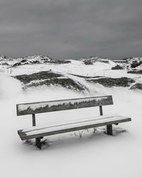 Snow covered landscape against sky