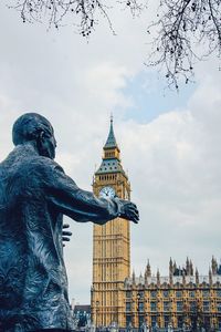 Low angle view of statue against cloudy sky