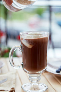 Making of sweet belgian chocolate with ice cream in glass on the terrace cafe. delicious breakfast.