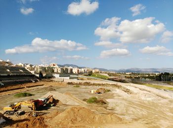 Panoramic view of construction site in city against sky
