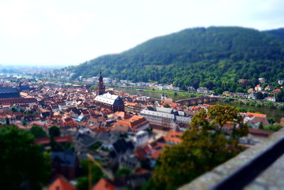 Tilt-shift image of cityscape against sky