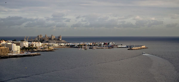 Scenic view of sea against sky in city