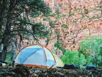 Tents by rock formations at zion national park