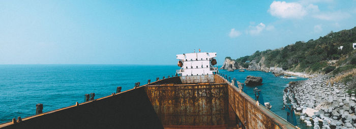 Panoramic view of building by sea against sky