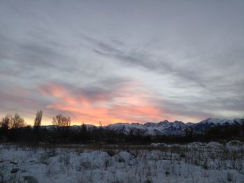 Scenic view of snowcapped mountains against sky during sunset