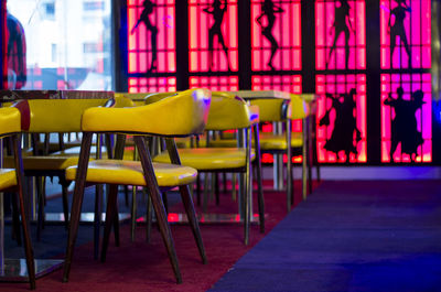 Empty chairs and table arranged in restaurant