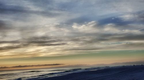 Scenic view of beach against sky during sunset