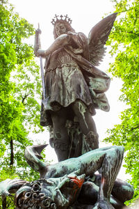 Low angle view of statue against trees