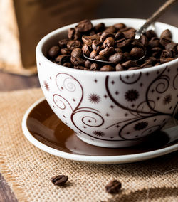 Cup full of coffee beans.