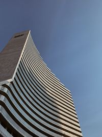 Low angle view of modern building against blue sky