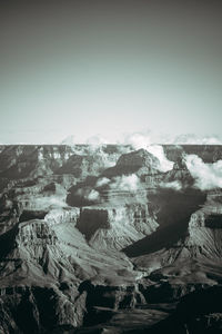 Aerial view of snowcapped mountains against clear sky