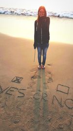 Full length of woman standing on beach