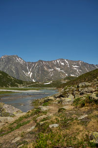 Scenic view of mountains against clear blue sky