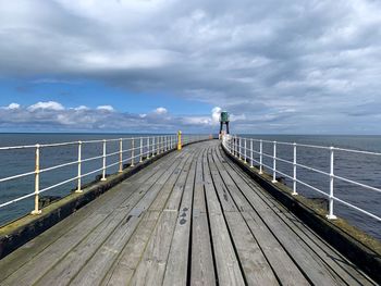 Pier over sea against sky