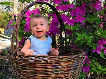 Portrait of smiling girl sitting in basket