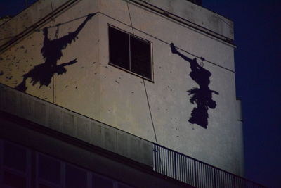 Bird on building against sky