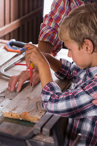 Full length of boy holding table at home