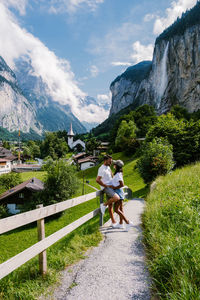 Rear view of people on mountain against sky