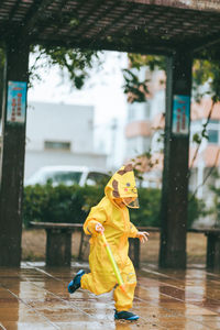 Full length of woman with umbrella in rain