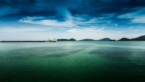 Boats in distance at sea against the sky