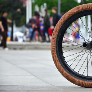 Close-up of bicycle wheel on road