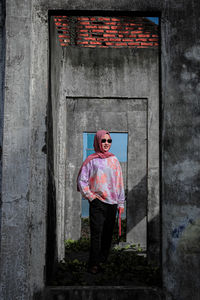 Full length of women standing against door